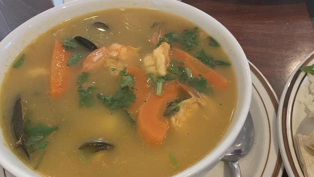 Sopa De Mariscos · Seafood soup with shrimp, scallops, squid, mussels, clams, and veggies.