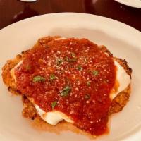 Chicken Parmigiana · Breaded chicken cutlet topped  with mozzarella cheese and our homemade red  gravy