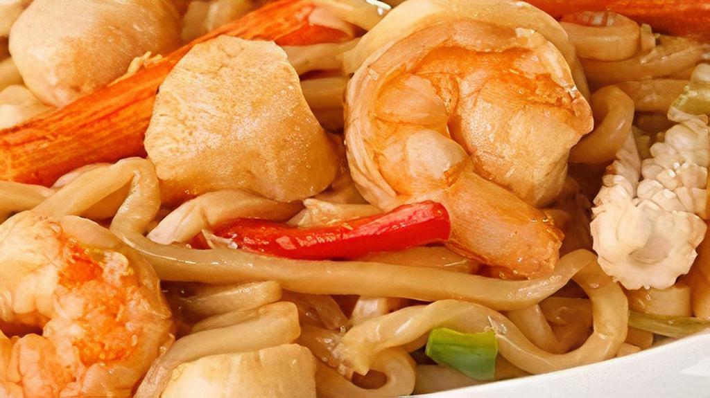 Yaki Udon · Japanese udon noodle pan fried with shrimp, crab sticks, scallops, fish cake and seasonal vegetables.