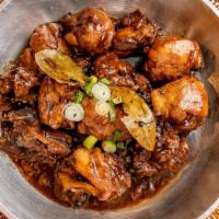 Chicken Adobo · Marinated chicken in a seasoned sauce and bay leaves.
