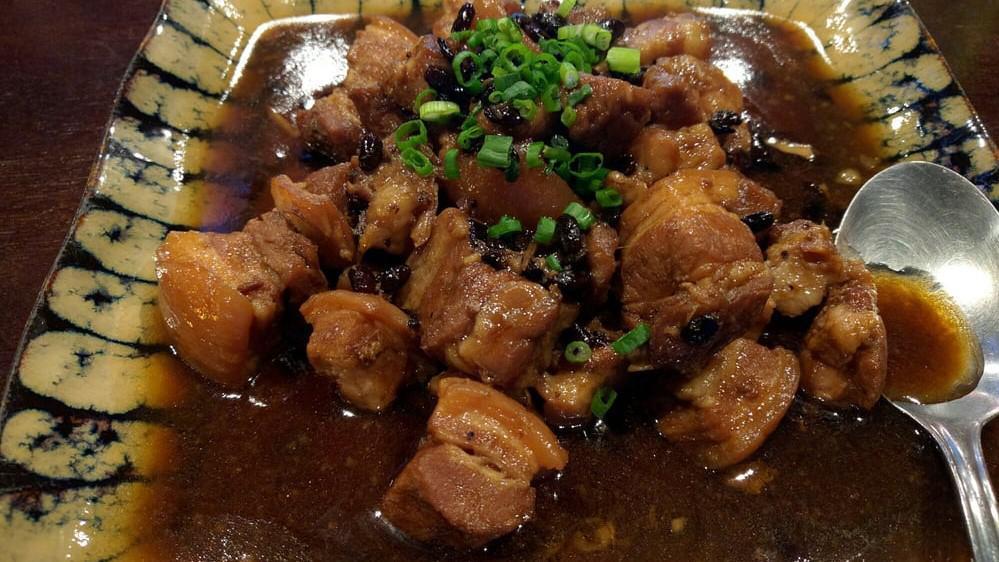Pork Adobo · Marinated pork in a seasoned sauce and bay leaves.