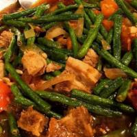 Adobong Sitaw · Stewed string beans in vinegar and soy sauce, topped with chopped crispy pork.