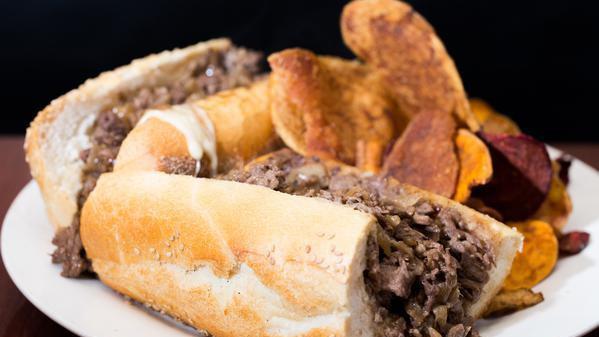Philly Cheesesteak · Sliced ribeye, cooper sharp cheese, seeded roll, and chips.