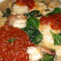 Ariana Chicken · Chicken breast, shrimp & scallops sauteed in EVOO & garlic. Served over spinach, with a touc...