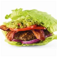 The Wedgie™ Burger · Hardwood-smoked bacon, housemade guac, tomatoes, and red onions in a lettuce bun. Served wit...