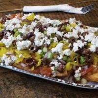 Greek Nachos · Fried pita chips, tomatoes, red onion, scallions, Kalamata olives, peperoncini peppers, and ...