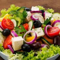 Greek Salad · Spinach and romaine base topped with tomatoes, cucumbers, red onions, pepperoncini peppers, ...