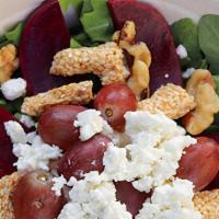 Yeeroh Salad · Arugula and spinach based with beet slices, sesame and honey bar, grapes, walnuts and goat c...