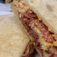 Reuben Sandwich · Slow cooked corned beef or turkey served on a toasted bread with Swiss cheese, coleslaw, and...