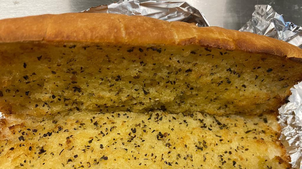 Garlic Bread · Bread, topped with garlic & olive oil or butter, herb seasoning, baked to perfection. Melts in your mouth and arouses the taste buds.
