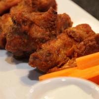 Buffalo Fried Wings · Fried chicken wings tossed in buffalo sauce and comes with ranch or blue cheese on the side