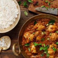 Chicken Curry · Tender piece of boneless chicken breast and thigh cooked with a traditional spices served wi...