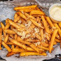 Parmesan French Fries · Parmesan dusted French fries and herbed truffled oil. Served with house aioli.