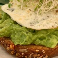 Avocado Toast · Whole avocado, parsley, lemon juice, olive oil, over easy egg, salt and pepper on multigrain...