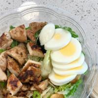Grilled Chicken Caesar Salad · Grilled chicken, lettuce, hard-boiled egg, croutons, shaved Parmesan cheese, Caesar dressing.