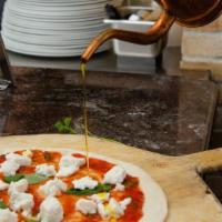 Buffalo Margherita Pizza · Tomato, buffalo, mozzarella and basil.