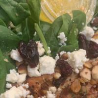 Baby Spinach Salad · Baby spinach, mushrooms, glazed walnuts, dried cranberries, goat cheese, and liquid gold dre...