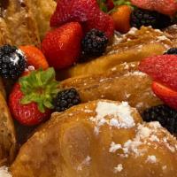 Fried French Toast · Topped with berries, powdered sugar and whip cream