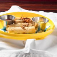 Cheese Steak Spring Rolls · Spicy ketchup and cheese sauce.