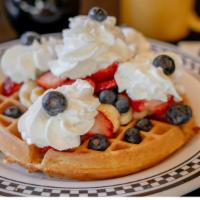The 3 Fruited Belgian Waffle · Our malted Belgium waffle topped with blueberries, strawberries, bananas and whipped cream.