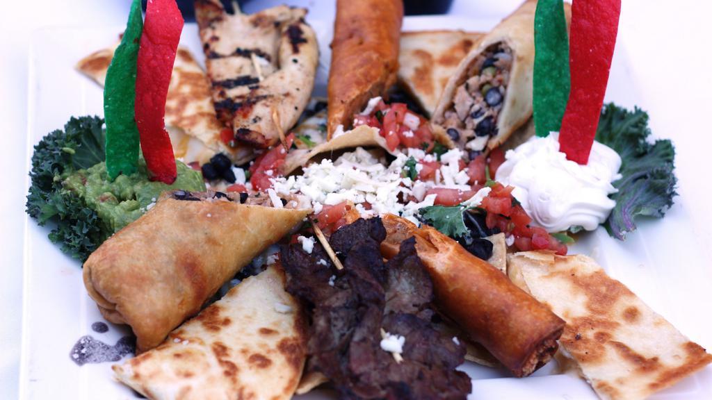 Ap: Fiesta Platter · Charbroiled chicken and steak skewers, Mex rolls, cheese quesadilla, chicken flautas, with cheese and black bean nachos. Served with pico de gallo, sour cream, and guacamole. Easily serves 2 people.