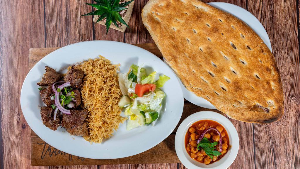 Lamb Kabob · Chunks of tender lamb, marinated in special spices, garlic and broiled on skewers over charcoal. Served with fresh homemade bread.