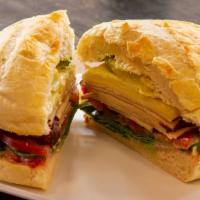 The Famous Arpeggio · Cranberry mayonnaise, turkey, tomatoes, spinach, cheddar and twice melted on a herb mini bou...
