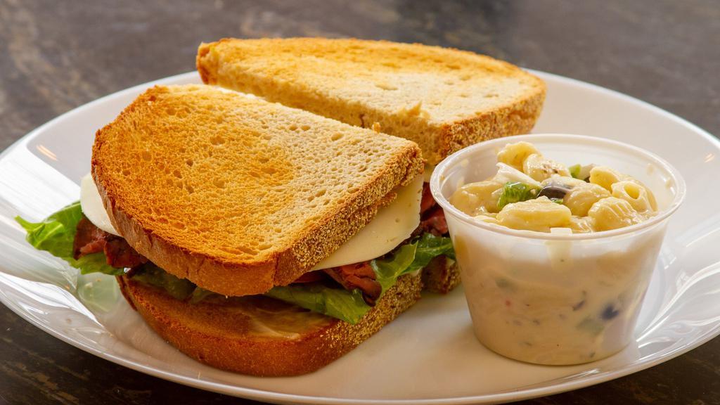 Roast Beef · Roast beef, lettuce, tomatoes, mayonnaise or mustard, choice of cheese and on your choice of bread.
