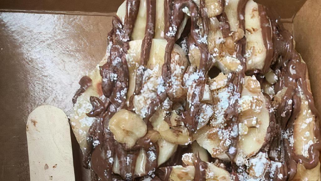 Nutella Crunch · Liege Waffle with Nutella drizzle, banana, chopped walnuts, more nutella drizzle, powdered sugar
