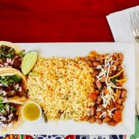 Tacos Combination · Three tacos served with your choice of meat, rice, and beans. Served in soft tortillas.