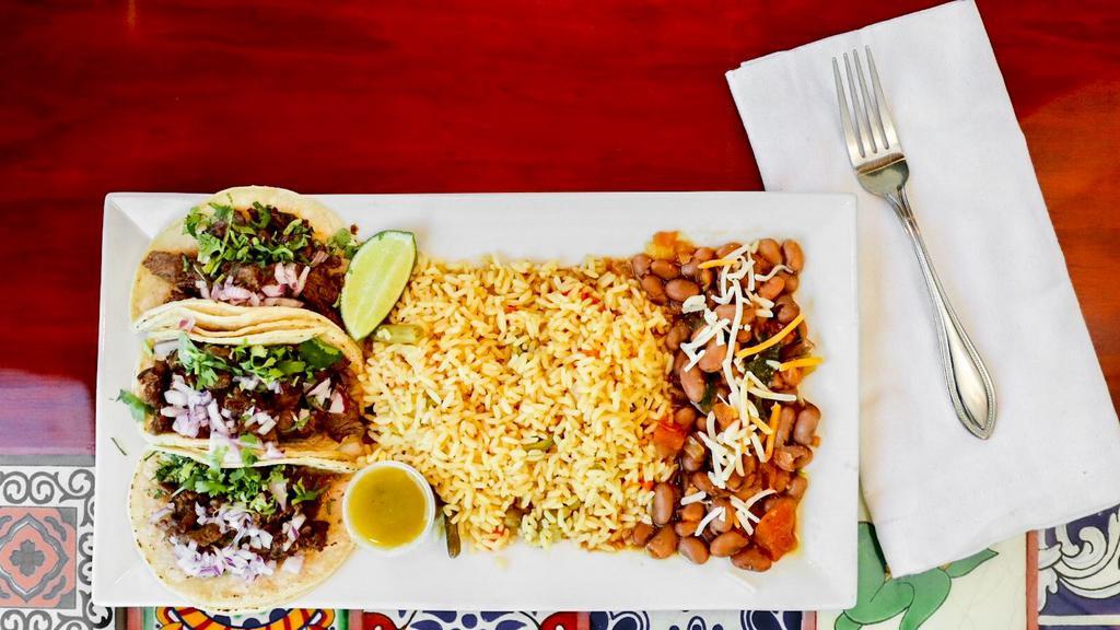 Tacos Combination · Three tacos served with your choice of meat, rice, and beans. Served in soft tortillas.