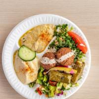 Veggie Combo Plate · Homemade falafel, stuffed grape leaves, fresh salad, tabbouleh, pickles, hummus, and rice.
