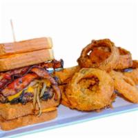 Duffy'S Monster Burger · 1/2 pound Angus burger topped with bacon, cheddar, and grilled onions, tucked between 2 gril...