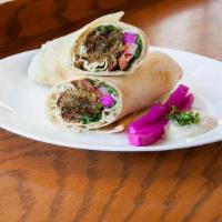 Falafel Sandwich · A pita wrap that comes with tomatoes, lettuce, radish, pickled turnips and tahini sauce in a...