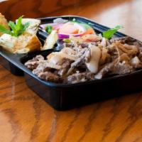 Beef Shawarma Platter · Marinated beef served over rice with a topping tahini sauce and sides of hummus and salad.gl...