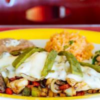 Alambre · Grilled steak, chicken, bacon covered in cheese, served with onion, bell peppers, cactus, pi...