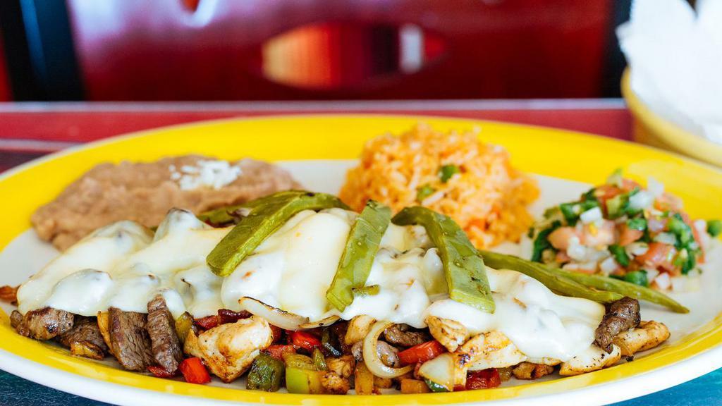 Alambre · Grilled steak, chicken, bacon covered in cheese, served with onion, bell peppers, cactus, pico de gallo, guacamole, rice & beans.