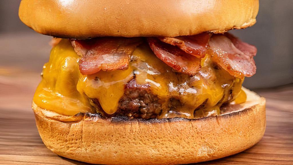 Bacon Cheeseburger Meal · 100% homemade beef pattie lightly salted and cooked to perfection. Served on a fresh bun with your choice of cheese.  2 slices and crispy bacon bits. Includes fries and a soda or water.