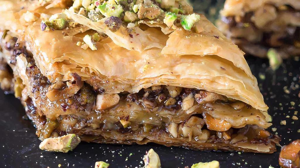 Greek Baklava · Layers of crispy golden brown phyllo dough,
filled with chopped walnuts and garnished with honey syrup