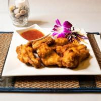 Crispy Thai Chicken Wings (6) · Fried chicken wings served with our famous Saap Lao Thai hot sauce.