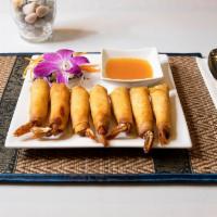 Shrimps In A Blanket (6) · Black tiger shrimp wrapped in a crispy thin spring roll served with a sweet chili sauce.