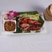 Grilled Lao Sausage · Herb filled grilled pork sausages served with sticky rice.