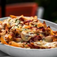 Cajun Salmon Loaded Fries · Golden crispy fries salted and fried to perfection and topped with Cajun salmon and melted c...