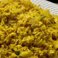 Pineapple Fried Rice · Pineapples, onions, scallions, egg, and turmeric powder
