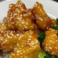 Honey Sesame Chicken* · Lightly coated chicken glazed with honey sesame over a bed of crispy rice noodles served wit...