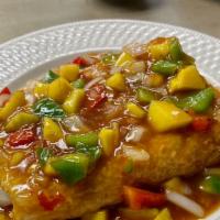 Tamarind Fish* · Lightly coated cod fish filet, diced bell peppers, mangos, onions, cilantro, and tamarind sa...