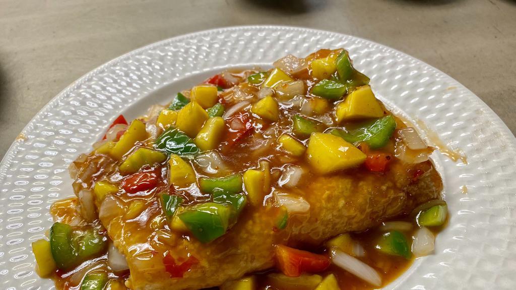 Tamarind Fish* · Lightly coated cod fish filet, diced bell peppers, mangos, onions, cilantro, and tamarind sauce