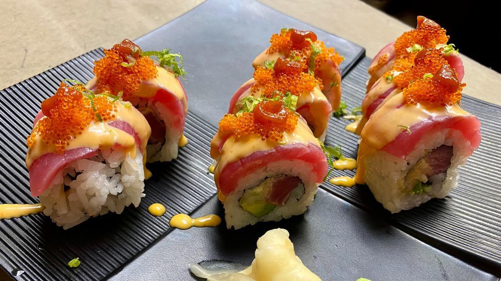 Volcano Maki* (Inside Out) · Spicy tuna, avocado, cucumber, topped with torched tuna, orange tobiko, scallions, spicy mayo, and hot and spicy sriracha sauce