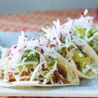 Pollo Tinga Tacos · Chicken tinga, shaved radish, crema, and queso fresco. Three per order.