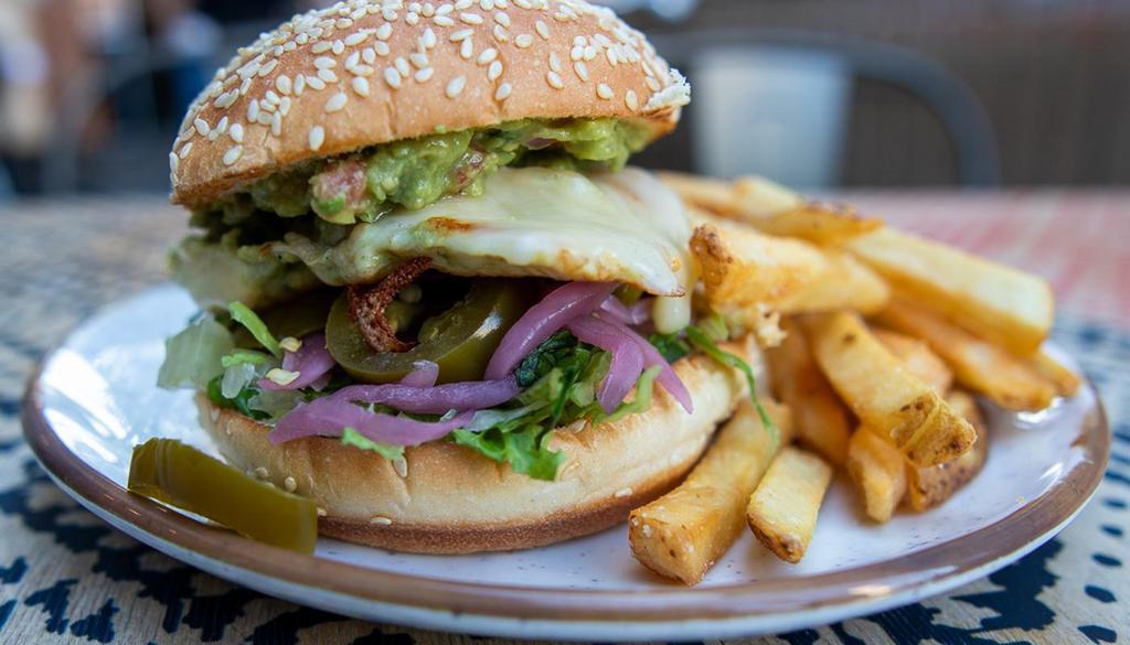 Southwest Chicken Sandwich · grilled chicken, chihuahua, guacamole, pickled onions, jalapenos, chipotle aioli, sesame seed bun, with fries